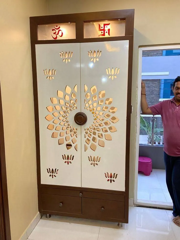 Pooja mandir with a floral CNC pattern on frosted doors, delivered to a client