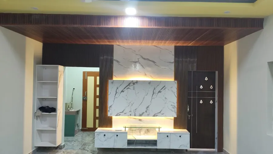 Living room TV unit with marble-pattern backing, wooden frame and white floating console