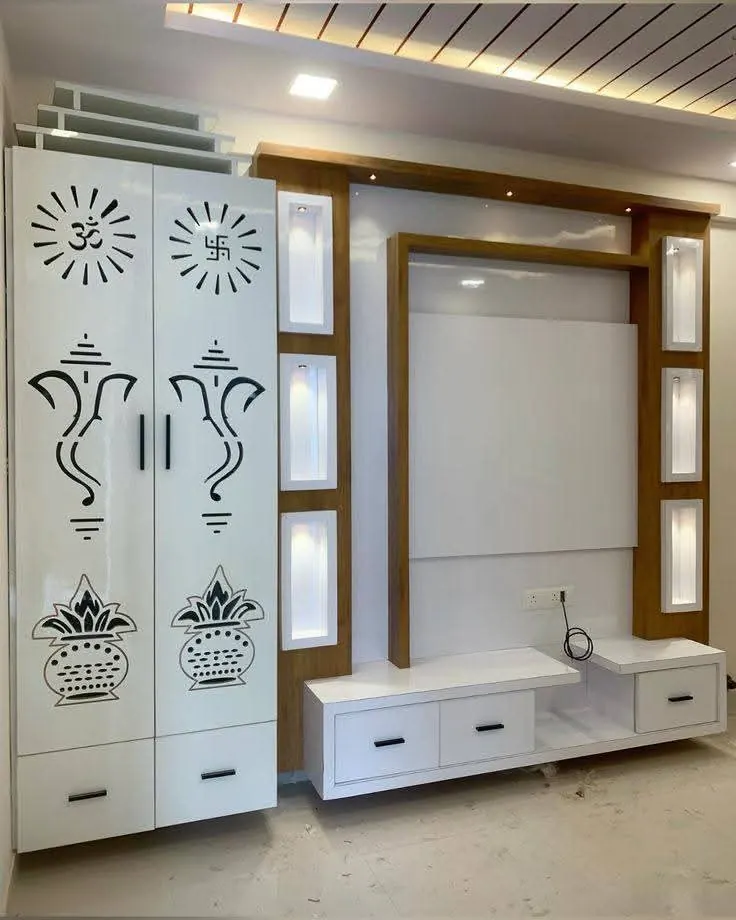 TV unit beside a white pooja cabinet with Ganesha CNC doors and lit niches