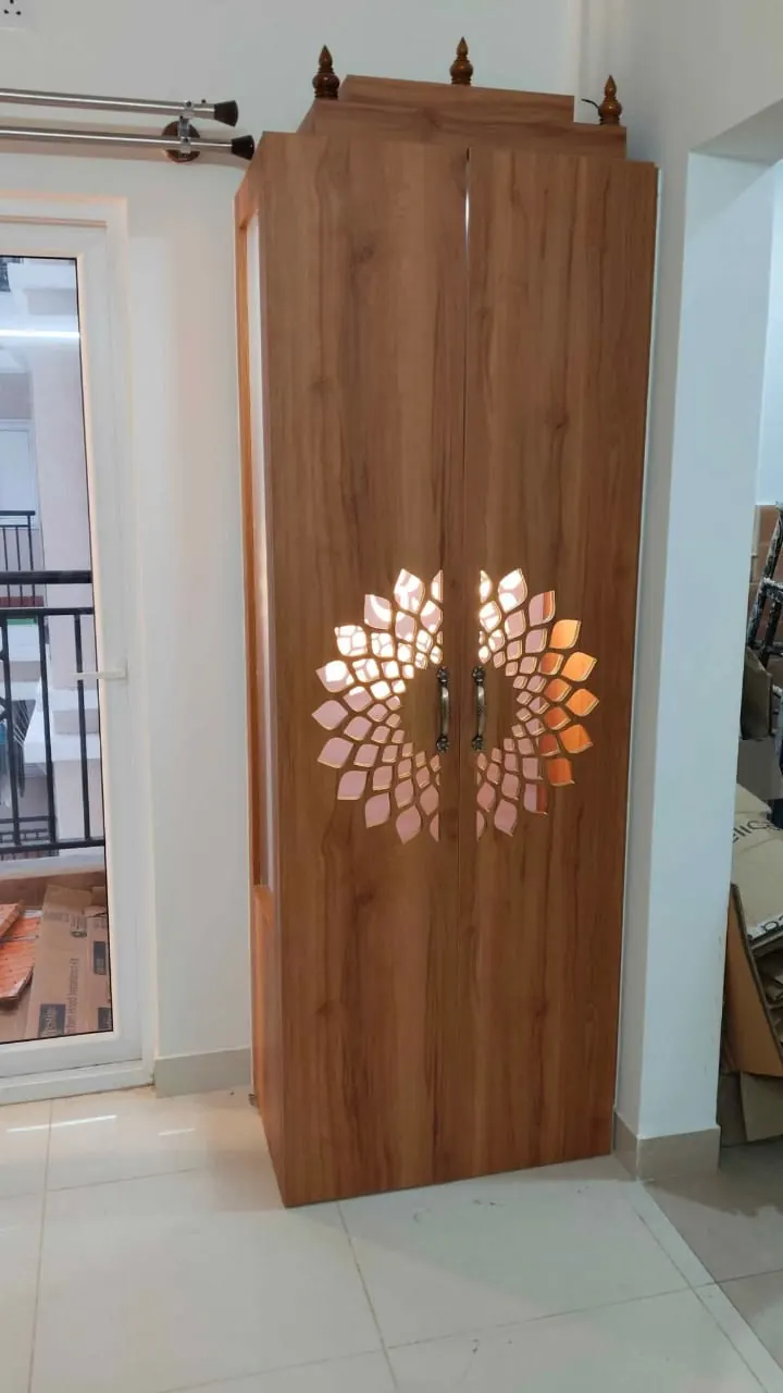 Tall teak-grain pooja cabinet with a circular jali pattern on the doors