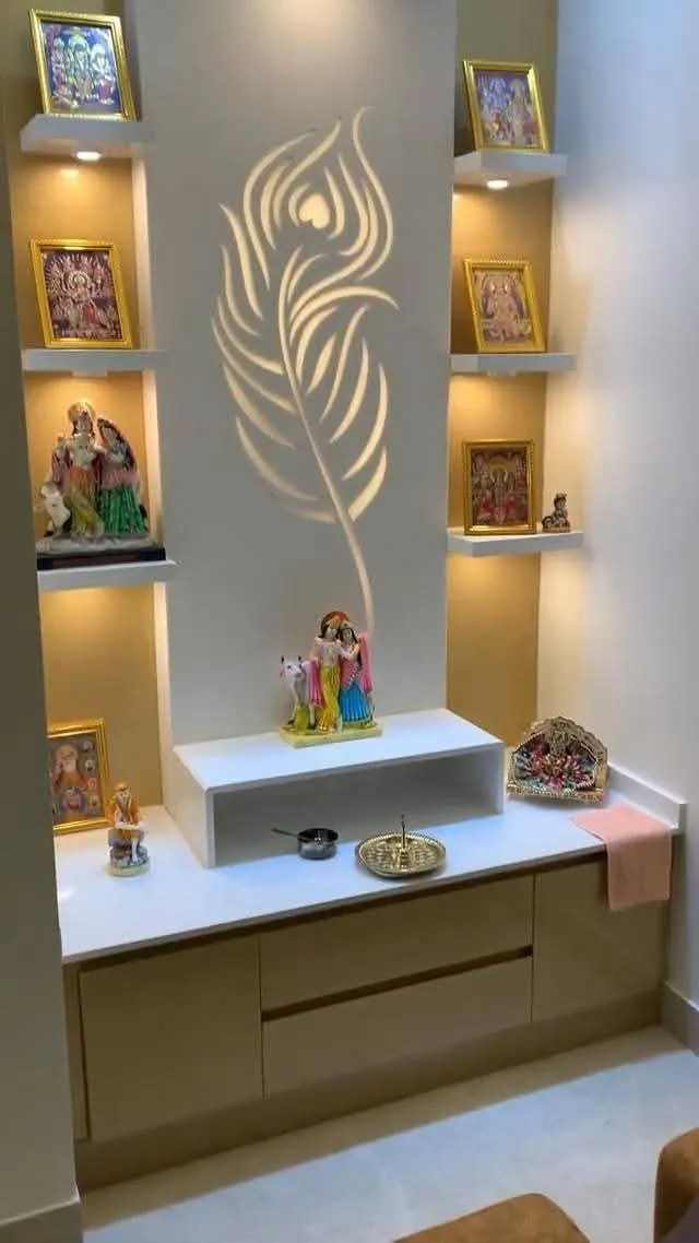 Pooja niche with a backlit peacock-feather cut-out and shelves for deity idols