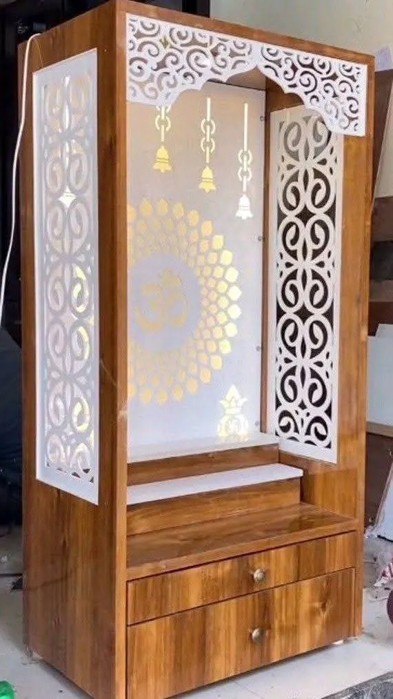 Floor-standing pooja mandir with carved jali panels, brass bells and drawers