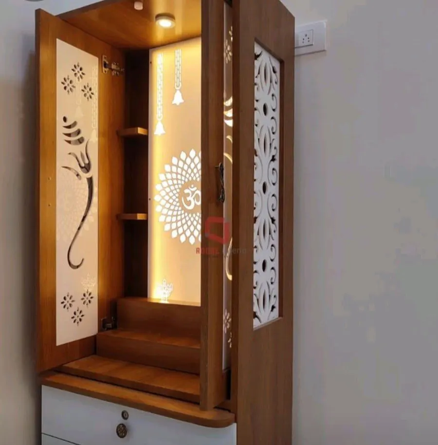 Teak-finish pooja mandir with Ganesha jali doors and warm interior lighting