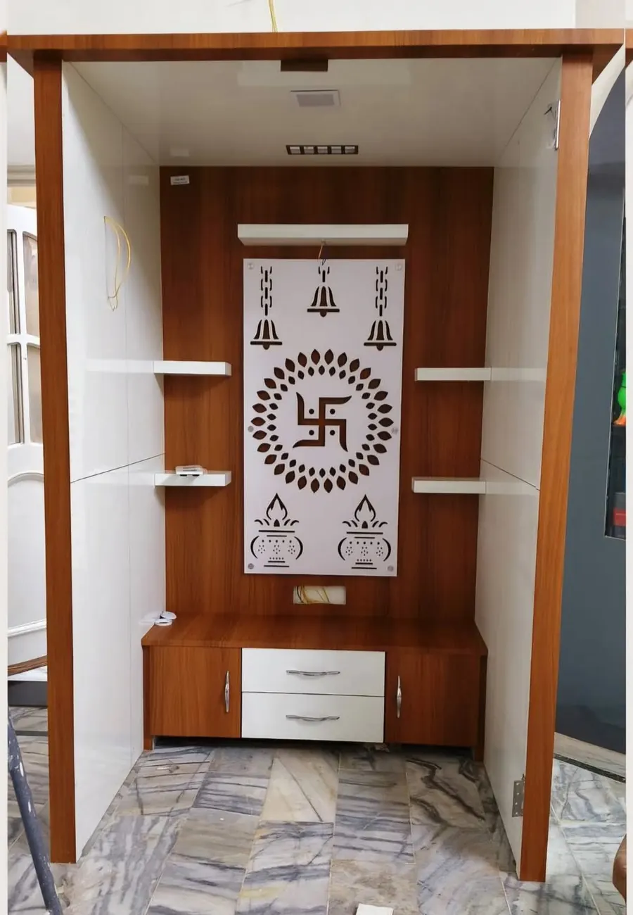 Walk-in pooja alcove with a swastika mandala backdrop and wooden frame